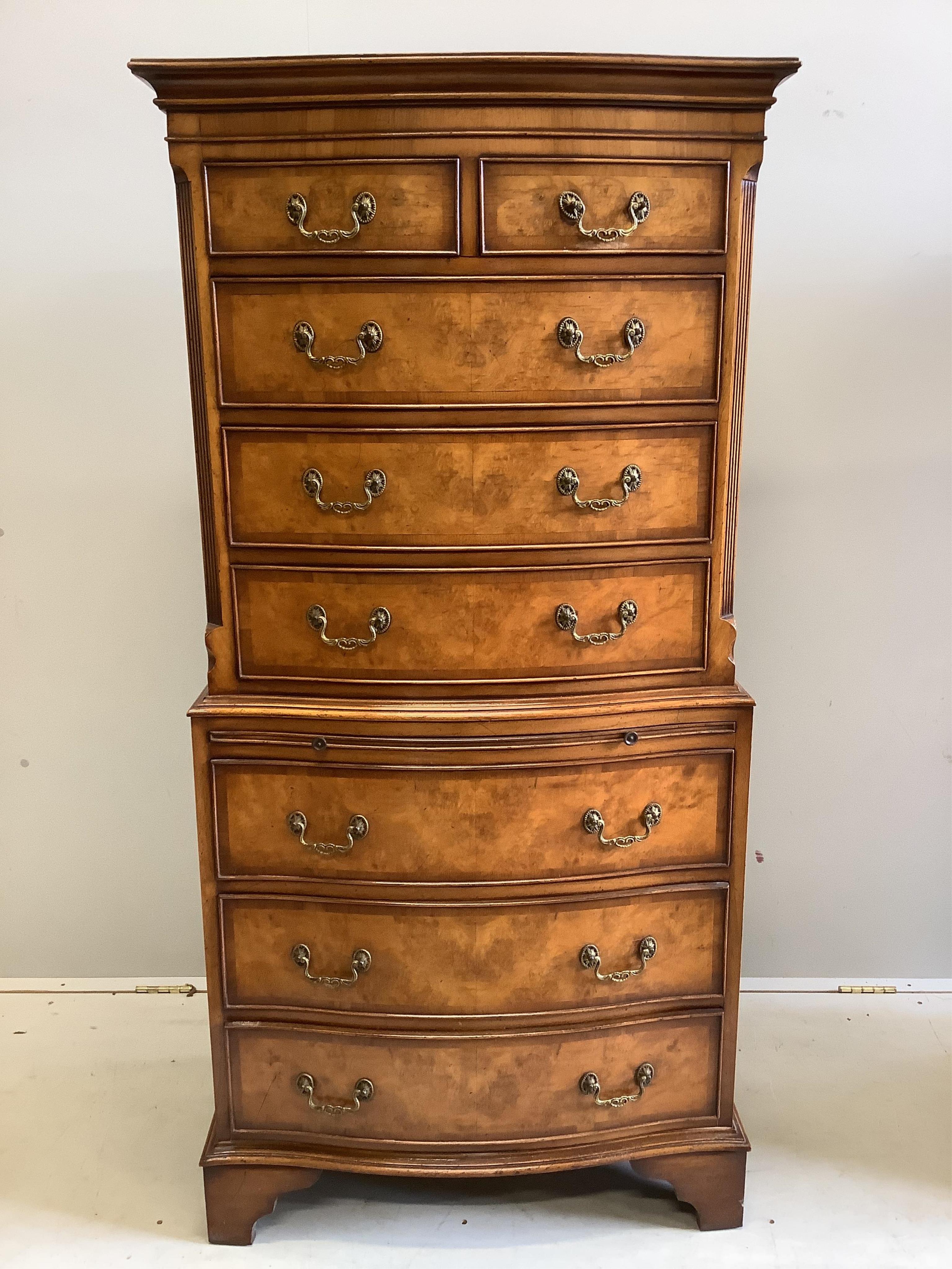 A pair of small reproduction George III style walnut bow front walnut chest on chests, width 72cm, depth 44cm, height 152cm. Condition - good